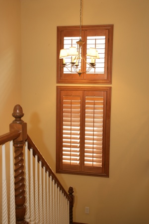 Wooden shutters in tan stairwell.